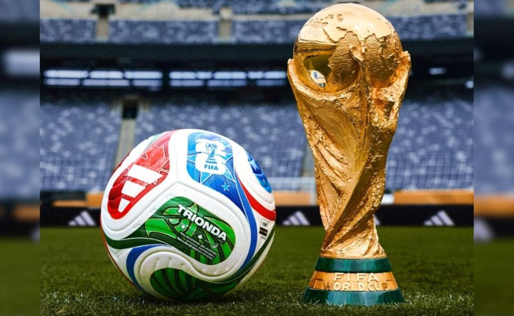 FIFA World Cup Trophy and Official Match Ball on Stadium Pitch