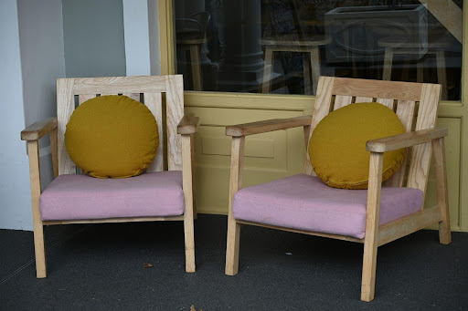 Custom wooden chairs designed for comfort and proportion in a small living area